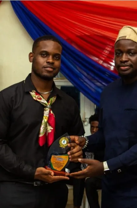Bright Uzosike, as Branch Director, being handed the award for AIESEC in Enugu as the top branch in operations in Nigeria