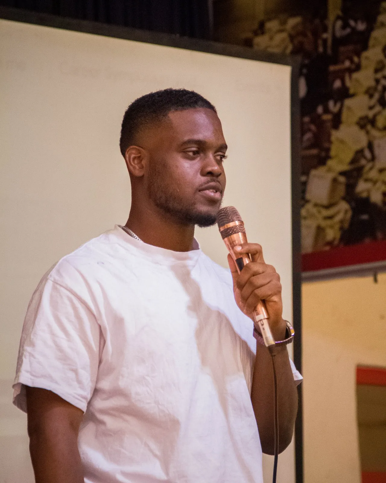 Bright Uzosike speaking into a microphone at a developers conference
